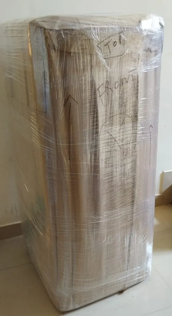 Tall appliance stretch-wrapped and labelled for relocation