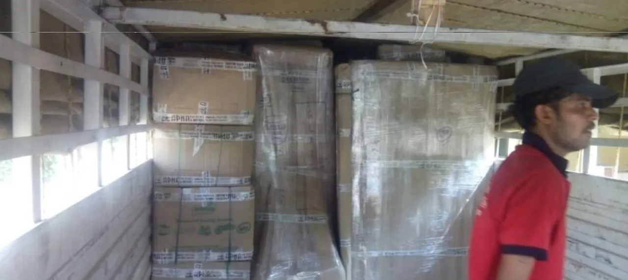 Our team loading packed cartons and wrapped furniture inside a truck